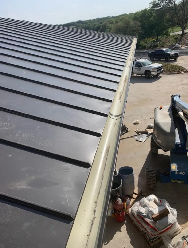 Standing seam panel and gutter detail on a metal roofing jobsite in Teaneck
